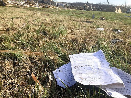 Pages from a recipe book lie in a yard Wednesday after a tornado destroyed much of a subdivision near McBroom Chapel Road in Putnam County, Tennessee, before dawn on Tuesday, March 3, 2020. (AP Photo/Travis Loller)