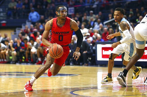 Dayton's Rodney Chatman (0) drives to the basket during the first half of an NCAA college basketball game against Rhode Island Wednesday, March 4, 2020, in Kingston, R.I. (AP Photo/Stew Milne)