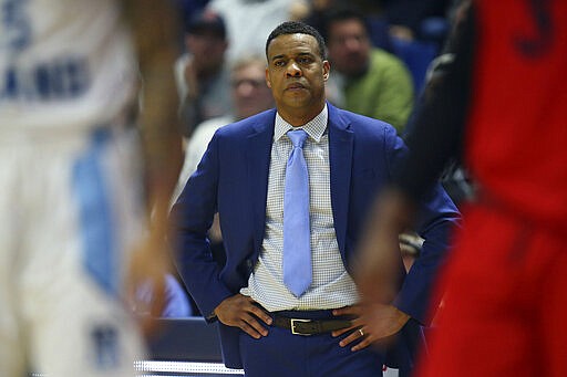 Rhode Island head coach David Cox looks on during the first half of an NCAA college basketball game against Dayton Wednesday, March 4, 2020, in Kingston, R.I. (AP Photo/Stew Milne)