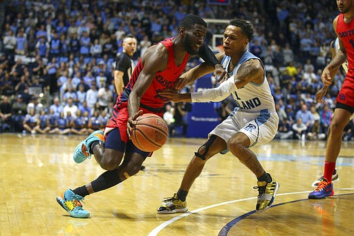 Dayton's Jalen Crutcher (10) drives to the basket as Rhode Island's Fatts Russell (1) defends during the first half of an NCAA college basketball game Wednesday, March 4, 2020, in Kingston, R.I. (AP Photo/Stew Milne)