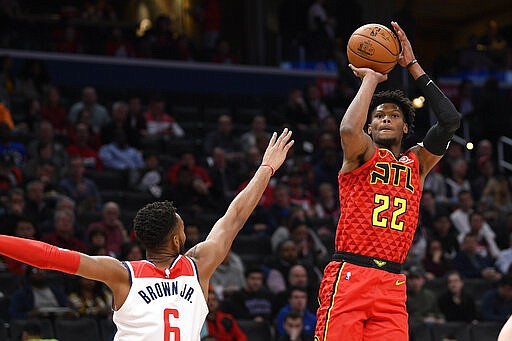 Atlanta Hawks guard Cam Reddish (22) shoots next to Washington Wizards forward Troy Brown Jr. (6) during the first half of an NBA basketball game, Friday, March 6, 2020, in Washington. (AP Photo/Nick Wass)