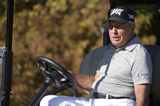 FILE - In this Dec. 7, 2019, file photo, Gary Player jokes with spectators after hitting a tee shot on the first hole during the first round of the Father Son Challenge golf tournament in Orlando, Fla. President Donald Trump is honoring a pair of retired pro golfers with the Presidential Medal of Freedom. The White House says Annika S&ouml;renstam and Player will receive the honors during a White House ceremony on March 23. (AP Photo/Phelan M. Ebenhack, File)