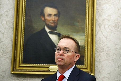 FILE - In this Nov. 13, 2019, file photo, acting chief of staff Mick Mulvaney listens as President Donald Trump and Turkish President Recep Tayyip Erdogan meet in the Oval Office with Republican senators at the White House in Washington.  President Donald Trump has named Rep. Mark Meadows, R-N.C., as his chief of staff, replacing Mulvaney. (AP Photo/Patrick Semansky, File)