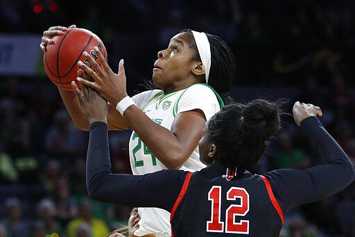 Oregon's Ruthy Hebard (24) shoots over Utah's Lola Pendande (12) during the second half of an NCAA college basketball game in the quarterfinal round of the Pac-12 women's tournament Friday, March 6, 2020, in Las Vegas. (AP Photo/John Locher)