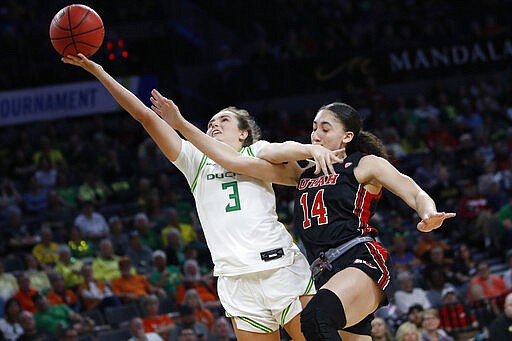 Utah's Niyah Becker (14) fouls Oregon's Taylor Chavez (3) during the second half of an NCAA college basketball game in the quarterfinal round of the Pac-12 women's tournament Friday, March 6, 2020, in Las Vegas. (AP Photo/John Locher)