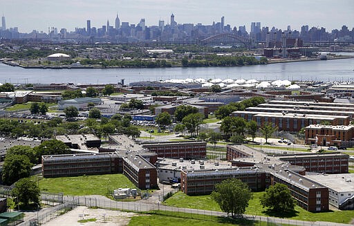 FILE - In a June 20, 2014, file photo, the Rikers Island jail complex stands in New York with the Manhattan skyline in the background. The nation&#146;s jails and prisons are on high alert about the prospect of the new coronavirus spreading through their vast inmate populations. (AP Photo/Seth Wenig, File)