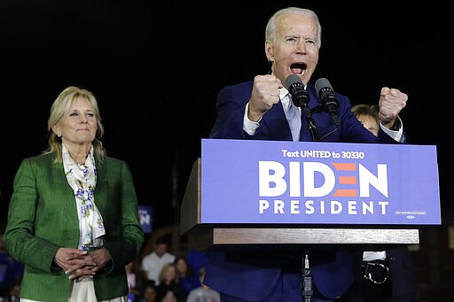 Democratic presidential candidate former Vice President Joe Biden, accompanied by his wife Jill, gestures as he speaks during a primary election night rally Tuesday, March 3, 2020, in Los Angeles. (AP Photo/Marcio Jose Sanchez)