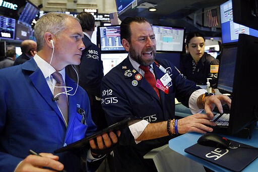 Trader Timothy Nick, left, and specialist Michael Pistillo work on the floor of the New York Stock Exchange, Tuesday, March 3, 2020. Stocks are opening lower on Wall Street after the Group of Seven countries held off on giving the global economy new stimulus to help it cope with the coronavirus outbreak. (AP Photo/Richard Drew)