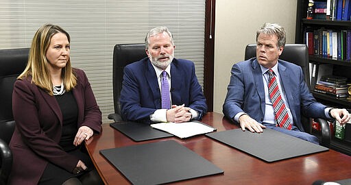 From left, Attorneys Jackie Cook, Mike Cox and David Shea hold a news conference regarding alleged sexual abuse claims by their clients against former University of Michigan doctor, Dr. Robert E. Anderson at the Mike Cox Law Firm office in Livonia, Mich., Wednesday, March 4, 2020. (Robin Buckson/Detroit News via AP)