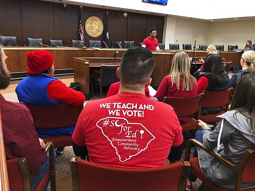 Caption Teachers with the group SC for Ed gather in a Statehouse meeting room as they prepare to lobby lawmakers on Wednesday, Jan. 29. 2020, in Columbia, S.C. The teachers took the day off to call for senators to not pass a massive education overhaul bill and take the proposals up in smaller parts. (AP Photo/ Jeffrey Collins)