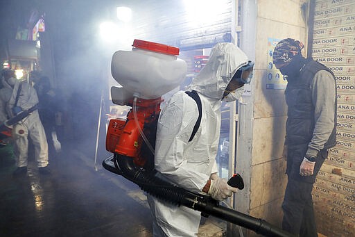 Firefighters disinfect a traditional shopping center to help prevent the spread of the new coronavirus in northern Tehran, Iran, Friday, March, 6, 2020.  A Health Ministry spokesman warned authorities could use unspecified &#147;force&#148; to halt travel between major cities. (AP Photo/Ebrahim Noroozi)