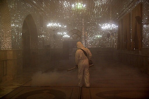 A firefighter disinfects the shrine of Saint Saleh to help prevent the spread of the new coronavirus in northern Tehran, Iran, Friday, March, 6, 2020.  A Health Ministry spokesman warned authorities could use unspecified &#147;force&#148; to halt travel between major cities. (AP Photo/Ebrahim Noroozi)