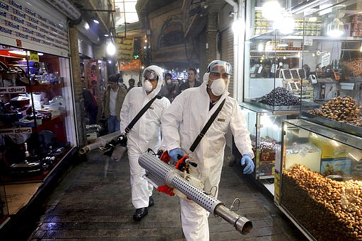 Firefighters disinfect a traditional shopping center to help prevent the spread of the new coronavirus in northern Tehran, Iran, Friday, March, 6, 2020.  A Health Ministry spokesman warned authorities could use unspecified &#147;force&#148; to halt travel between major cities. (AP Photo/Ebrahim Noroozi)