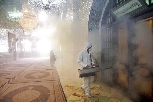 A firefighter disinfects the shrine of Saint Saleh to help prevent the spread of the new coronavirus in northern Tehran, Iran, Friday, March, 6, 2020.  A Health Ministry spokesman warned authorities could use unspecified &#147;force&#148; to halt travel between major cities.  (AP Photo/Ebrahim Noroozi)