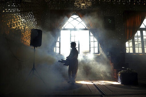 A firefighter disinfects the shrine of Saint Saleh to help prevent the spread of the new coronavirus in northern Tehran, Iran, Friday, March, 6, 2020. A Health Ministry spokesman warned authorities could use unspecified &#147;force&#148; to halt travel between major cities.  (AP Photo/Ebrahim Noroozi)