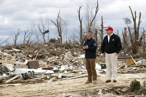 President Donald Trump speaks Mike Herrick, with Putnam County Rescue Squad, as he tours damage from a recent tornado, Friday, March 6, 2020, in Cookeville, Tenn. (AP Photo/Alex Brandon)