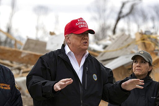 President Donald Trump speaks, accompanied by Maria Lee, wife of Tennessee Gov. Bill Lee, as they tour damage from a recent tornado, Friday, March 6, 2020, in Cookeville, Tenn. (AP Photo/Alex Brandon)