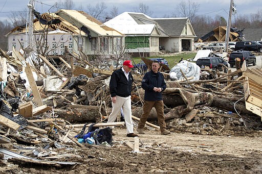 President Donald Trump speaks Mike Herrick, with Putnam County Rescue Squad, as he tours damage from a recent tornado, Friday, March 6, 2020, in Cookeville, Tenn. (AP Photo/Alex Brandon)