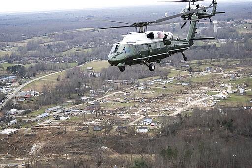 Marine One, with President Donald Trump aboard, left, flies over damage after a recent tornado, Friday, March 6, 2020, taken on the plane in flight over Cookeville, Tenn. (AP Photo/Alex Brandon)