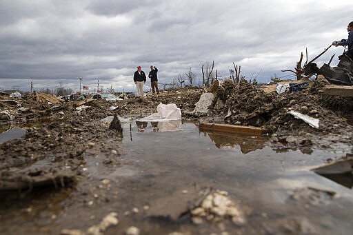 President Donald Trump speaks Mike Herrick, with Putnam County Rescue Squad, as he tours damage from a recent tornado, Friday, March 6, 2020, in Cookeville, Tenn. (AP Photo/Alex Brandon)