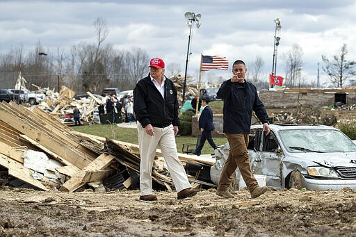 President Donald Trump speaks Mike Herrick, with Putnam County Rescue Squad, as he tours damage from a recent tornado, Friday, March 6, 2020, in Cookeville, Tenn. (AP Photo/Alex Brandon)