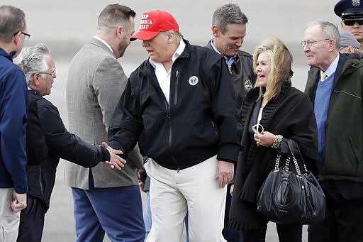 President Donald Trump is greeted by Nashville Mayor John Cooper, second from left, Friday, March 6, 2020, in Nashville, Tenn. Trump is in Tennessee to view tornado damage. (AP Photo/Mark Humphrey)