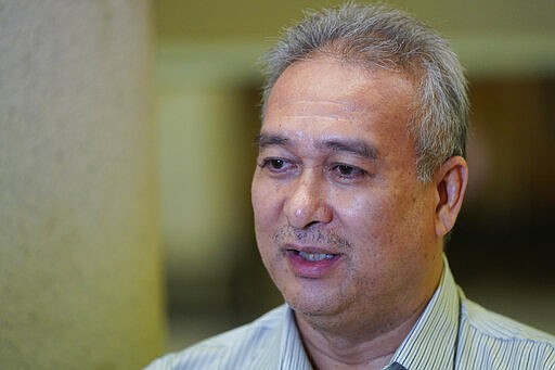 Thaib Mustafa, brother of Mastura Mustafa, who was a flight attendant on MH17, speaks to Associated Press in Kuala Lumpur, Malaysia, Tuesday, March 3, 2020. United by grief across oceans and continents, families who lost loved ones when Malaysia Airlines Flight 17 was shot down in 2014 hope that a trial starting next week will finally deliver them something that has remained elusive ever since: The truth. (AP Photo/Vincent Thian)