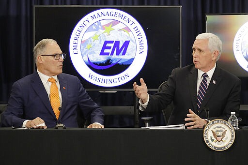 Vice President Mike Pence, right, talks with Washington Gov. Jay Inslee, left, during a meeting with officials Thursday, March 5, 2020 at Camp Murray in Washington state to discuss the state's efforts to fight the spread of the COVID-19 coronavirus. (AP Photo/Ted S. Warren)