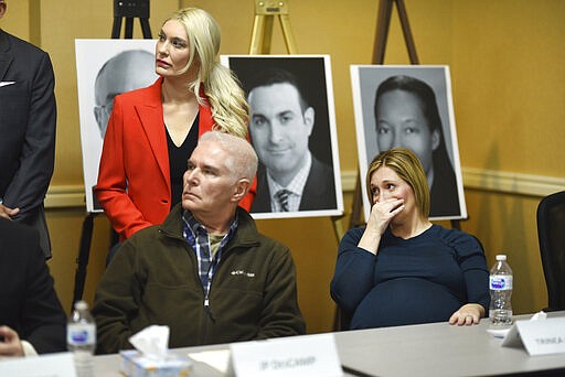 Attorney Sarah Klein, left and Dr. Anderson abuse survivor JP DesCamp listen as Trinea Gonczar, a Dr. Larry Nassar survivor, reacts to graphic statements made against former University of Michigan doctor Robert E. Anderson for systematic sexual assault as they speak to the media in Ypsilanti on Thursday, March 5, 2020. (Max Ortiz/Detroit News via AP)