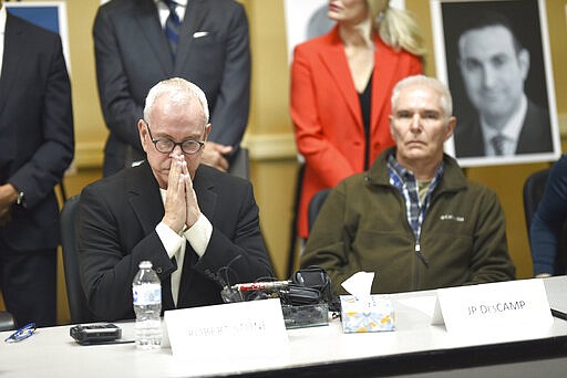 Abuse survivor Robert Stone, left, shows his emotion with JP DesCamp as they speak to the media in Ypsilanti on Thursday, March 5, 2020. (Max Ortiz/Detroit News via AP)