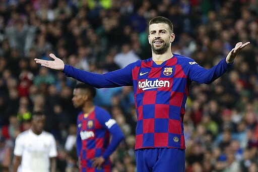 Barcelona's Gerard Pique reacts during the Spanish La Liga soccer match between Real Madrid and Barcelona at the Santiago Bernabeu stadium in Madrid, Spain, Sunday, March 1, 2020. (AP Photo/Manu Fernandez)