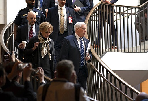 Vice President Mike Pence, center, joined at left by Dr. Deborah Birx, the coronavirus response coordinator, arrives at the Capitol to brief House members on the COVID-19 outbreak, in Washington, Wednesday, March 4, 2020. Congressional negotiators have reached agreement on an $8.3 billion bill to fund the government's response to the public health emergency. (AP Photo/J. Scott Applewhite)