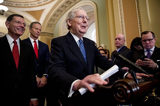 Senate Majority Leader Mitch McConnell of Ky., center, accompanied by Sen. John Barrasso, R-Wyo., left, and Senate Majority Whip Sen. John Thune, R-S.D., second from left, speaks at a news conference after meeting with Vice President Mike Pence, the head of President Donald Trump's coronavirus task force, on Capitol Hill, Tuesday, March 3, 2020, in Washington. (AP Photo/Andrew Harnik)