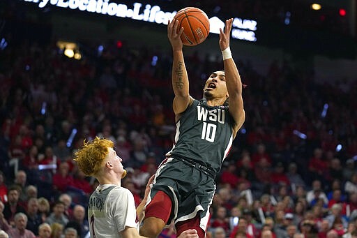 Washington State guard Isaac Bonton (10) drives past Arizona guard Nico Mannion in the first half of an NCAA college basketball game Thursday, March 5, 2020, in Tucson, Ariz. (AP Photo/Rick Scuteri)