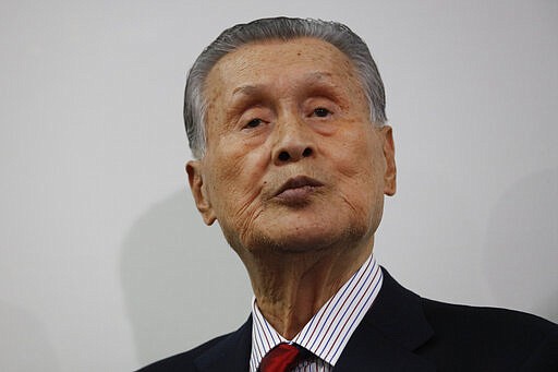 In this March 4, 2020, photo, Tokyo 2020 Organizing Committee's Yoshiro Mori, listens to questions from the media during a news conference in Tokyo. The Olympic Games are under threat from a spreading virus from China that has reached the pandemic stage. The head of the Tokyo Olympics on Friday, March 6, 2020, said organizers are downsizing the arrival ceremony in Japan for the Olympic torch on March 20 because of the spreading coronavirus. (AP Photo/Jae C. Hong)