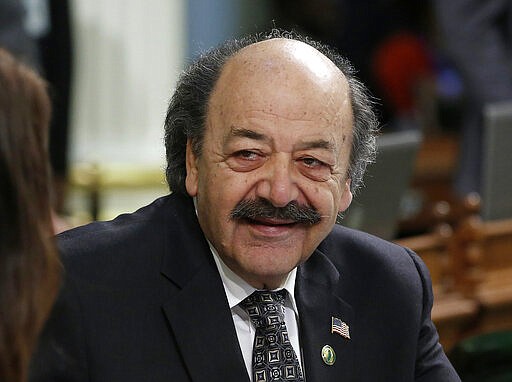 FILE - In this Thursday, April 21, 2016, file photo, Assemblyman Katcho Achadjian, R-San Luis Obispo, talks with Assemblywoman Melissa Melendez, R-Lake Elsinore, at the Capitol in Sacramento, Calif. Achadjian, who represented California's Central Coast in the state Assembly for three terms, died Thursday, March 5, 2020, according to a news report. (AP Photo/Rich Pedroncelli, File)