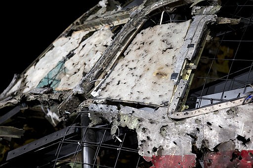 FIlE - In this Tuesday, Oct. 13, 2015, file image, the reconstructed cockpit of Malaysia Airlines Flight MH17 plane is displayed before a news conference by the Dutch Safety Board in Gilze-Rijen, Netherlands. United by grief across oceans and continents, families who lost loved ones when Malaysia Airlines Flight 17 was shot down in 2014 hope that a trial starting next week will finally deliver them something that has remained elusive ever since: The truth. (AP Photo/Peter Dejong, File)