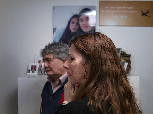 Pictures and mementos of their son Bryce and his girlfriend Daisy, rear, still adorn the walls of the house of Silene and Rob Fredriksz in Rotterdam, Netherlands, Tuesday, Feb. 25, 2020. United by grief across oceans and continents, families who lost loved ones when Malaysia Airlines Flight 17 was shot down in 2014 hope that a trial starting next week will finally deliver them something that has remained elusive ever since: The truth. (AP Photo/Peter Dejong)