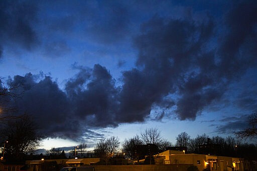 The sun goes down over the over the house of Silene and Rob Fredriksz in Rotterdam, Netherlands, Tuesday, Feb. 25, 2020. The couple lost their son Bryce and his girlfriend Daisy when a missile fired from territory controlled by pro-Russian rebels in Ukraine tore the MH17 passenger jet apart. United by grief across oceans and continents, families who lost loved ones when Malaysia Airlines Flight 17 was shot down in 2014 hope that a trial starting next week will finally deliver them something that has remained elusive ever since: The truth. (AP Photo/Peter Dejong)