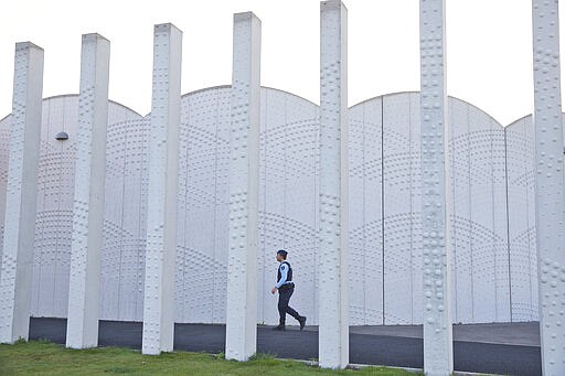 FILE - In this Monday, Oct. 31, 2016, file image, a Dutch military police officer walks towards the entrance of the extra secure court building at Schiphol airport, near Amsterdam, Netherlands. United by grief across oceans and continents, families who lost loved ones when Malaysia Airlines Flight 17 was shot down in 2014 hope that a trial starting next week will finally deliver them something that has remained elusive ever since: The truth. (AP Photo/Peter Dejong, File)