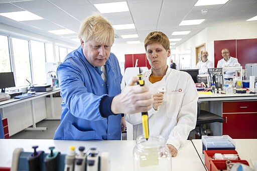 Britain's Prime Minister Boris Johnson visits the Mologic Laboratory in the Bedford technology Park, England, Friday March 6, 2020. (Jack Hill/Pool via AP)