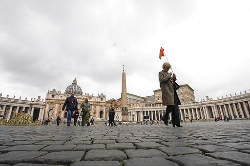 People walk in St. Peter's Square at the Vatican, Friday, March 6, 2020. A Vatican spokesman has confirmed the first case of coronavirus at the city-state. Vatican spokesman Matteo Bruni said Friday that non-emergency medical services at the Vatican have been closed so they can be sanitized following the positive test on Thursday. (AP Photo/Andrew Medichini)