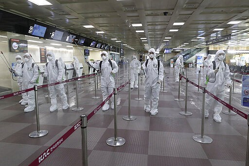 South Korean army soldiers wearing protective suits spray disinfectant to prevent the spread of the new coronavirus at Daegu International Airport in Daegu, South Korea, Friday, March 6, 2020. Seoul expressed &#147;extreme regret&#148; Friday over Japan&#146;s ordering 14-day quarantines on all visitors from South Korea due to a surge in viral infections and warned of retaliation if Tokyo doesn&#146;t withdraw the restrictions.  (Kim Joo-sung/Yonhap via AP)