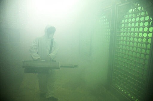 A firefighter disinfects the shrine of Saint Saleh to help prevent the spread of the new coronavirus in northern Tehran, Iran, Friday, March, 6, 2020.  A Health Ministry spokesman warned authorities could use unspecified &#147;force&#148; to halt travel between major cities.  (AP Photo/Ebrahim Noroozi)