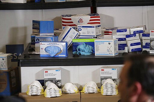 Masks, gloves, and other protective supplies are displayed during a visit of Vice President Mike Pence, Thursday, March 5, 2020 to Camp Murray in Washington state. Pence was in Washington to discuss the state's efforts to fight the spread of the COVID-19 coronavirus. (AP Photo/Ted S. Warren)