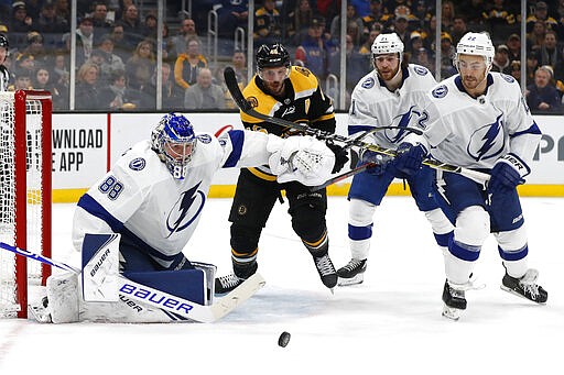 Boston Bruins' David Krejci (46) tries to get through Tampa Bay Lightning's Brayden Point, Kevin Shattenkirk (22) and goaltender Andrei Vasilevskiy (88) to get to the puck during the second period of an NHL hockey game Saturday, March 7, 2020, in Boston. (AP Photo/Winslow Townson)