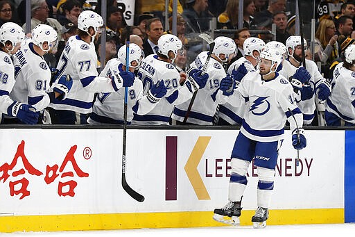 Tampa Bay Lightning's Cedric Paquette is congratulated at the bench after scoring against the Boston Bruins during the second period of an NHL hockey game Saturday, March 7, 2020, in Boston. (AP Photo/Winslow Townson)