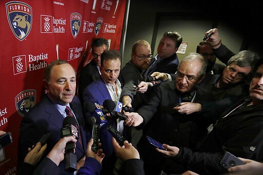 National Hockey League Commissioner Gary Bettman, left, speaks to members of the media , Saturday, March 7, 2020, in Sunrise, Fla. (AP Photo/Wilfredo Lee)