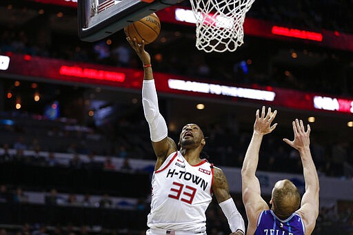 Houston Rockets forward Robert Covington, left, drives for a layup past Charlotte Hornets center Cody Zeller during the second half of an NBA basketball game in Charlotte, N.C., Saturday, March 7, 2020. (AP Photo/Nell Redmond)