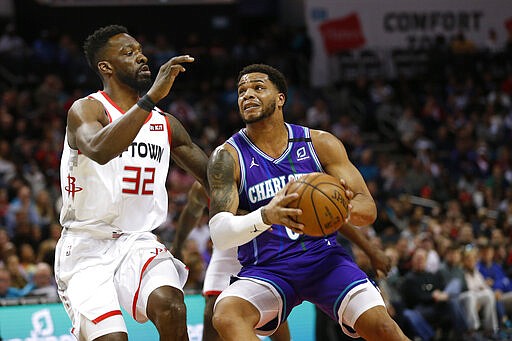 Charlotte Hornets forward Miles Bridges, right, drives to the basket against Houston Rockets forward Jeff Green during the first half of an NBA basketball game in Charlotte, N.C., Saturday, March 7, 2020. (AP Photo/Nell Redmond)